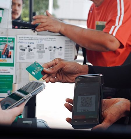 A man holding a phone and credit card at checkout